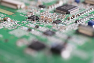 Detail of an electronic printed circuit board with many electrical components with narrow depth of field.