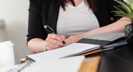 Businesswoman signing a document