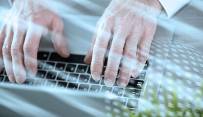 Male hands working on laptop; light effect