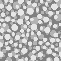 Seamless pattern of gray circles on a dark gray background