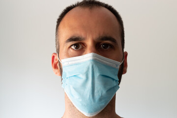 Caucasian man with beard and face mask on white background.