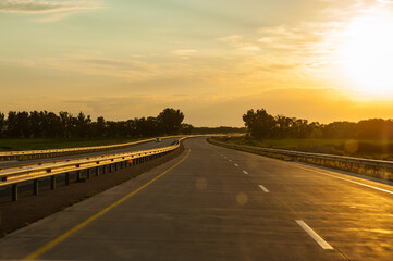 Sunset on the road going to the mountains