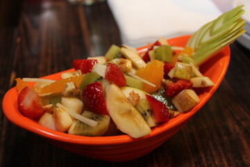 Fresh Fruit Salad in Red Bowl on Dark Background