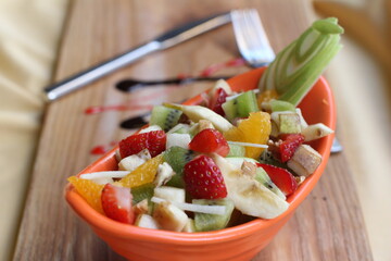 Fresh Fruit Salad in Red Bowl on Dark Background