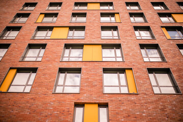 old brick building.A wall with many windows. 