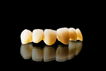 white ceramic teeth isolated on black background