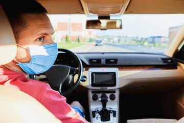 Fototapeta na wymiar Man in the medical mask in car. coronavirus, disease, infection, quarantine, covid-19