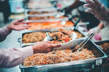The hands of beggars receive donated food : concept of charity food for the poor