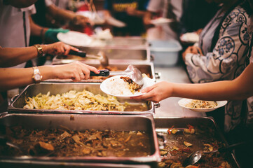 The hands of beggars receive donated food : concept of charity food for the poor