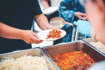 The hands of beggars receive donated food : concept of charity food for the poor