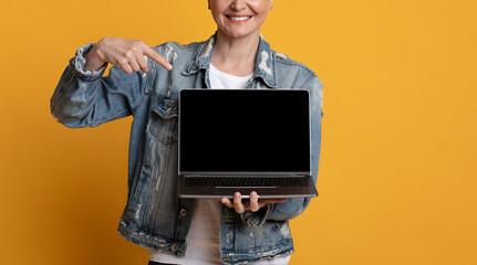 New Website. Unrecognizable Middle-Aged Lady Pointing At Laptop With Blank Black Screen