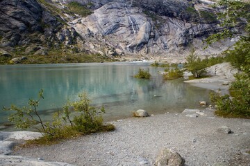 Scenic view of Nigardsbreen glacier and Nigardsbrevatnet lake surrounded by mountains - Jostedalsbreen national park, Norway