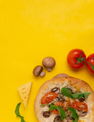 Vegetarian pizza with mushrooms, tomatoes and herbs. Ingredients. Notepad.