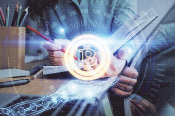 Cryptocurrency hologram over woman's hands writing background. Concept of blockchain. Multi exposure
