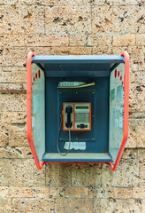 Old street pay phone, mounted on brick wall