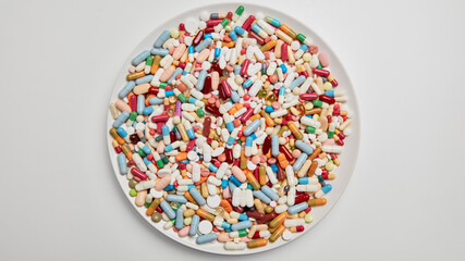 Round plate with colorful medication from above