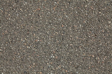 An old asphalt surface, background. Detailed texture of the bitumen close-up. Screen short. Road foundation