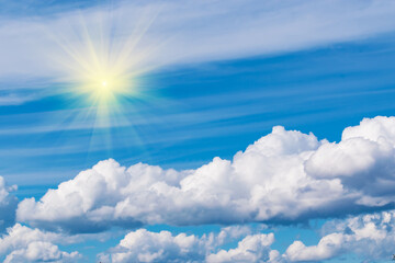 Naklejka na ściany i meble Bright blue sky with white clouds, illuminated by the sun. Beautiful summer landscape.