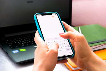 Businesswoman using laptop and mobile phone