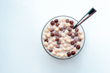 Bowl with chocolate corn balls on white background. Cereals. the view from the top