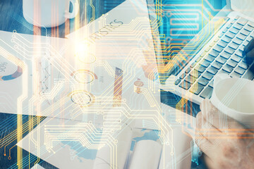 Double exposure of world map hologram with man working on computer on background. Concept of worldwideweb.