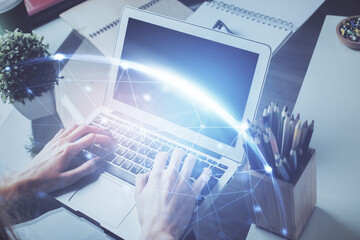 Media network theme hologram with man working on computer on background. Concept of internet communication. Double exposure.