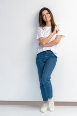 Full portrait of a beautiful young happy woman standing over white background.