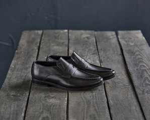 black loafers on a wooden