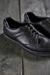Fototapeta na wymiar black shoes on a wooden