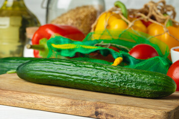 Two cucumbers on wooden kitchen table close up