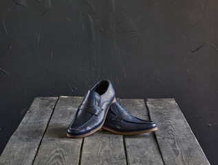 blue loafers on a wooden