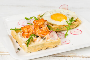 Waffles with eggs, tomatoes, radishes and herbs. Close-up shot