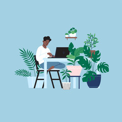 A person staying home working on the laptop in the kitchen. A room full of plants.