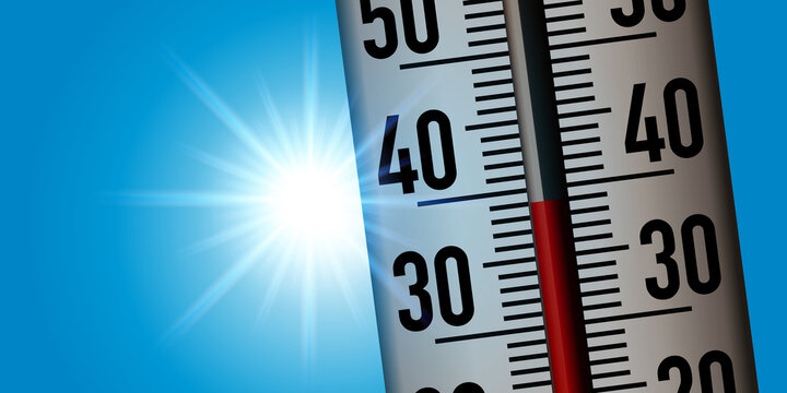 Concept de la canicule avec un thermomètre pris en gros plan pour montrer la hausse des températures suite au réchauffement climatique.