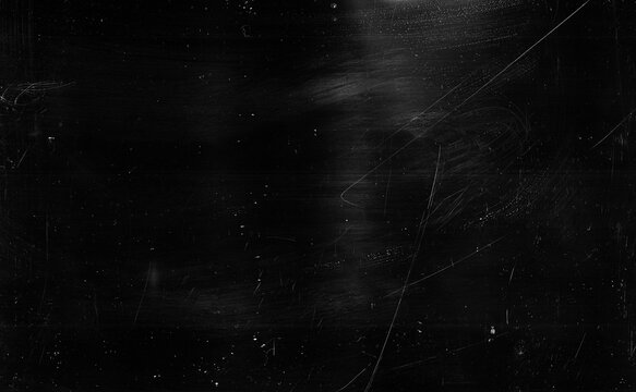 Dust scratches background. Grain texture. Black distressed surface with white smeared stains.