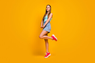 Fototapeta na wymiar Full length body size view of her she nice attractive lovely winsome lovable cheerful cheery straight-haired girl posing having fun isolated over bright vivid shine vibrant yellow color background