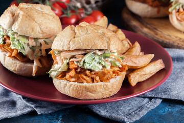 Pulled chicken sandwich with salad and bbq sauce