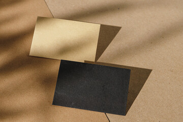 Foliage shadow on paper background with business card