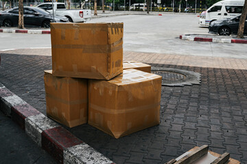 Cardboard boxes waiting for transport to customer at bus terminal.