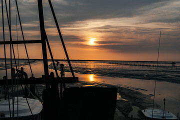 Beautiful sunset view at dawn on sea fisher man boat in Thailand.