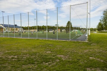 View of children playing football on outdoor playground. Sweden.
