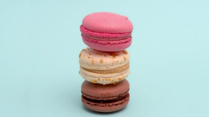 Stop motion animation of colorful macarons on blue
