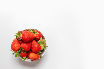 Bowl with fresh strawberries on white background. Summer composition