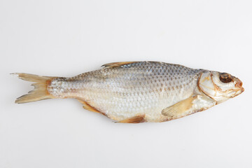 isolated close up top view shot of a single Russian dried salted vobla (Caspian Roach) fish on a white background