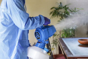 Cleaning and disinfecting: Key weapons in the fight against contagious diseases. Spray disinfection of surfaces in the house. Fogging with disinfectant due to coronavirus.