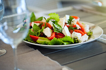Serving of vegetable salad with cheese on the table