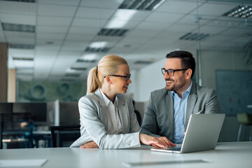 Work romance. Two business people looking at each other and smiling, portrait.