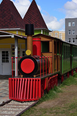 red train on railway station