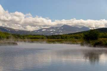 Daytime view of the lake in windy weather. With a view of the volcano on the horizon. A view from...