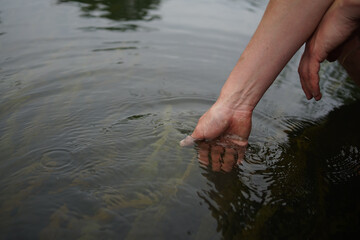 Hands dipping in river water    